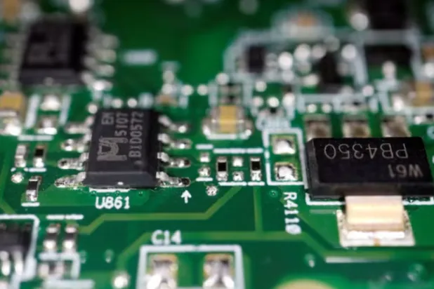 Semiconductor chips are seen on a printed circuit board in this illustration picture taken February 17, 2023. REUTERS/Florence Lo/Illustration