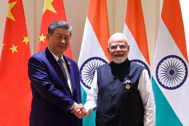 This handout photograph taken on September 12, 2026 and released by the Indian Press Information Bureau (PIB) shows India's Prime Minister Narendra Modi (R) and China's President Xi Jinping shaking hands during a bilateral meeting on the sidelines of the 18th BRICS Summit at the Bharat Mandapam in New Delhi on September 12, 2026. (Handout / Indian Press Information Bureau (PIB) / AFP) 