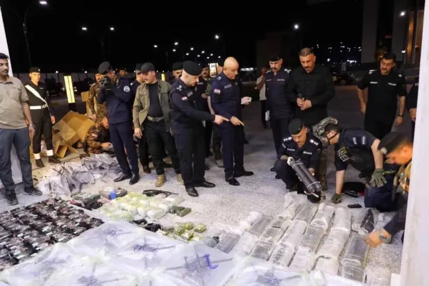 Police officers in Iraq’s Anbar province inspect projectiles and drones seized in the governorate (Security Media) 
