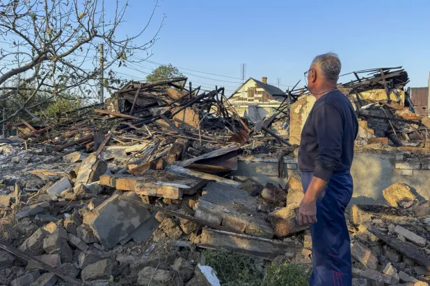 A person inspects the damage at the site of a Russian strike on a building in Zaporizhzhia, Ukraine, 12 September 2026. (EPA)