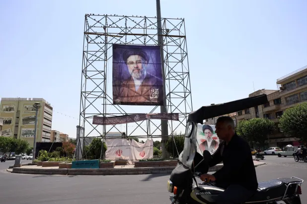 A man drives next to a billboard of Iranian supreme leader Mojtaba Khamenei in a street in Tehran, Iran, 09 July 2026. EPA/ABEDIN TAHERKENAREH