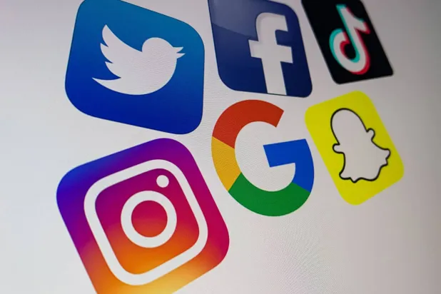 (FILES) A photo taken on October 21, 2020 shows the logo of the multinational American Internet technology and services company, Google (center), the American online social media and social networking service, Facebook (Top R), Snapchat (Bottom R), Twitter (top L) and Instragram (bottom L) on a computer screen in Lille. (Photo by DENIS CHARLET / AFP)