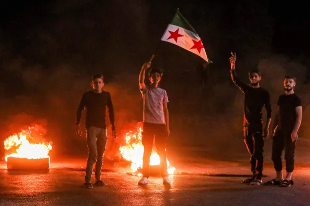 Demonstrators block a road with flaming tires while protesting hikes to fuel prices in al-Bab, northeast of Aleppo in northern Syria, on September 14, 2026. (AFP)