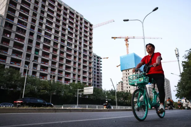 A person rides a bike on a street in Beijing, China, 15 September 2026. (EPA)
