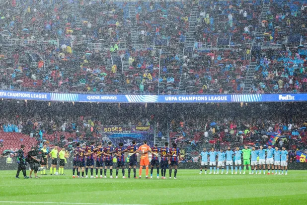  Players observe a minute of silence in remembrance of the victims of the recent devastating floods in Nepal, before the start of the UEFA Champions League first round day 1 football match between FC Barcelona and Feyenoord at Camp Nou stadium in Barcelona on September 9, 2026. (AFP)