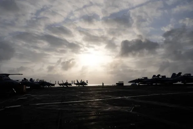 A US Navy sailor walks across the flight deck of the USS George Washington in the Arabian Sea, September 11, 2026. (Reuters)
