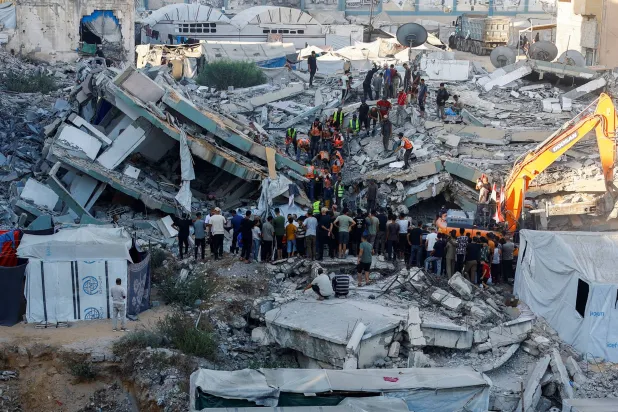  People gather as Civil Defense workers attempt to rescue those who are trapped beneath the rubble of a residential building that had been damaged in an earlier Israeli strike during the war and collapsed on Wednesday, in Gaza City, September 16, 2026. (Reuters)