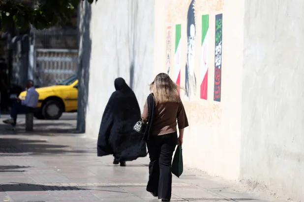 Iranian women walk in a street on the fourth anniversary of protests following Mahsa Amini's death in downtown Tehran, Iran, 16 September 2026. (EPA)