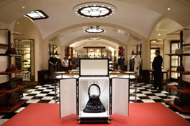 Prada bags and women’s clothes are displayed in its historic store in Milan's Galleria Vittorio Emanuele II, in Milan, Italy, September 15, 2026. REUTERS/Claudia Greco