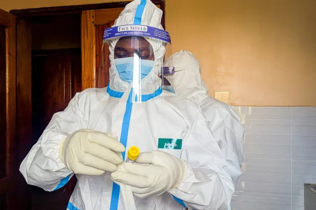 A member of the civil protection team's dignified and safe burial service prepares to swab the body of a child suspected of having died from Ebola at the Butembo Unit Hospital morgue, in Butembo, North Kivu province, Democratic Republic of Congo, September 13, 2026. (Reuters)