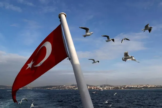 FILE PHOTO: A Turkish flag flies on a passenger ferry with the Bosphorus in the background in Istanbul, Türkiye, January 27, 2020. REUTERS/Murad Sezer
