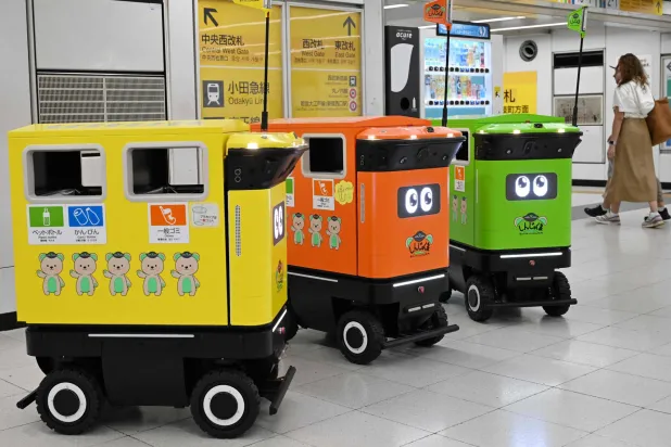Mobile robotic trash bins are pictured during testing at the Shinjuku Station transport complex in Tokyo on September 18, 2026. (Photo by Toshifumi KITAMURA / AFP)