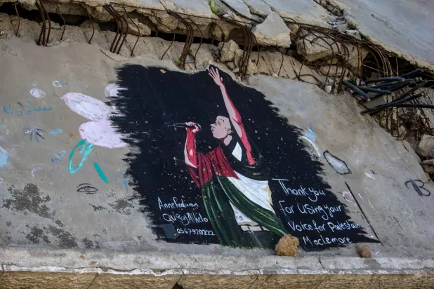 A mural by Palestinian artists depicts US rapper Macklemore on the ruins of homes in Gaza City, 19 September 2026. (EPA)