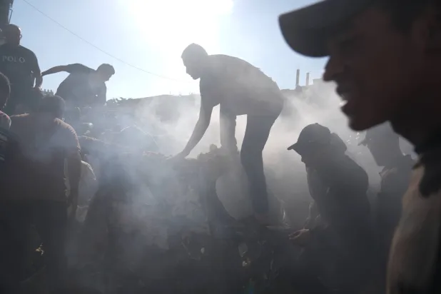  People operate on a destroyed vehicle following an Israeli airstrike in Gaza city, Saturday, Sept. 19, 2026. (AP) 