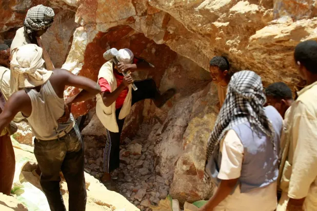 Workers break rocks at a gold mine near Abu Delelq in Gadarif State, Sudan. (Reuters)