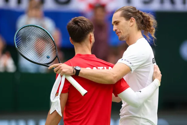 Germany's Alexander Zverev, right, after defeating Croatia's Dino Prizmic in their Davis Cup second qualifying round tennis match in Halle, Germany, Sunday, Sept. 20, 2026. (Christoph Reichwein/dpa via AP)