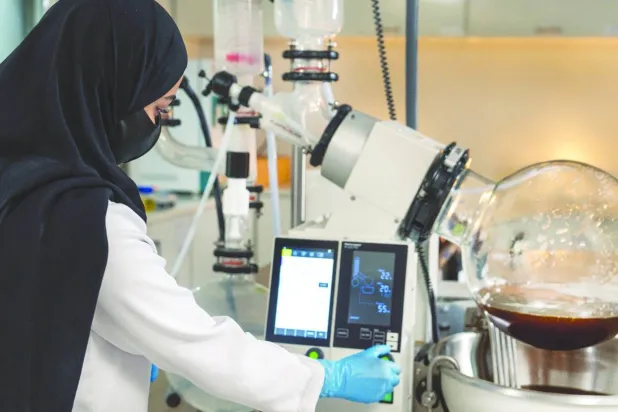 A Saudi woman works on products derived from the Peregrina tree in AlUla.