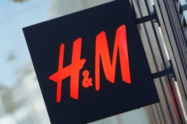 The logo for H&M is displayed outside a store in Stockholm, Sweden, September 23, 2025. REUTERS/Tom Little/File Photo 