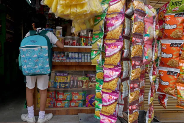 A schoolchild inside a grocery shop in Cuttack, Odisha, India, September 18, 2026. REUTERS/Priyanshu Singh