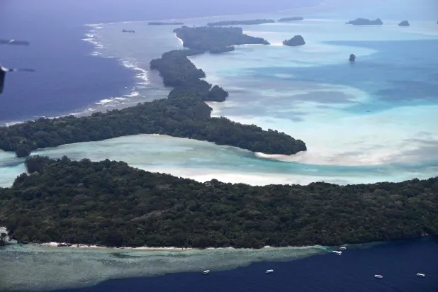 This picture taken on September 4, 2026, shows an aerial view of the small islands off the coast of Koror, the capital of Palau, scattered across the turquoise waters of the Pacific Ocean. (AFP)