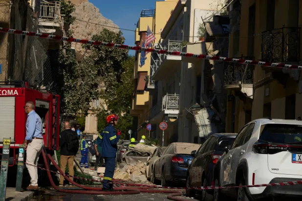 Firefighters work at the scene following a powerful blast that caused a building to collapse and injured at least two people in Athens' Plaka district, Friday, Sept. 25, 2026. (AP Photo/Petros Giannakouris)
