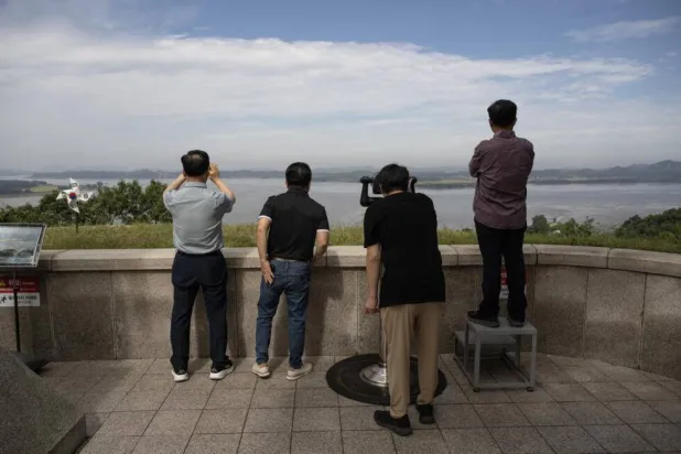 Visitors look towards North Korea, which has worked to seal off links to the outside world. Lillian SUWANRUMPHA / AFP
