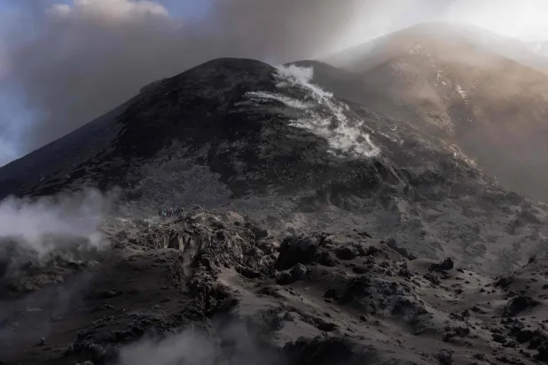 Visitors climb Mount Etna as smoke rises from its volcano in Catania, on the Mediterranean island of Sicily, on September 28, 2026. (Photo by Roman PILIPEY / AFP)