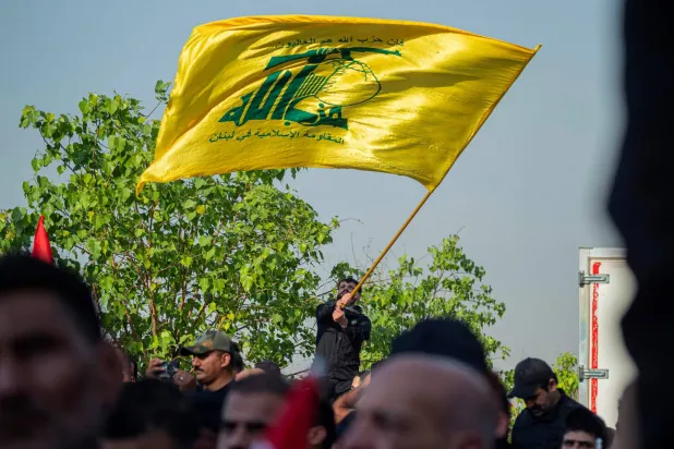 A man waves Hezbollah flag at the Tahrir Square in Baghdad on September 26, 2026, to mark the second anniversary of killing of Hezbollah's former chief Hassan Nasrallah, in a major strike by Israel on Beirut's southern suburbs in Lebanon. (AFP)