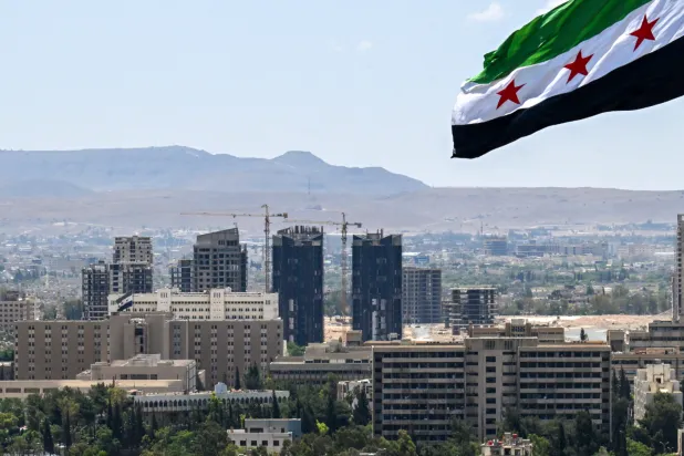 A large Syrian flag flutters above Tishreen Park in Damascus on June 4, 2025. (AFP)