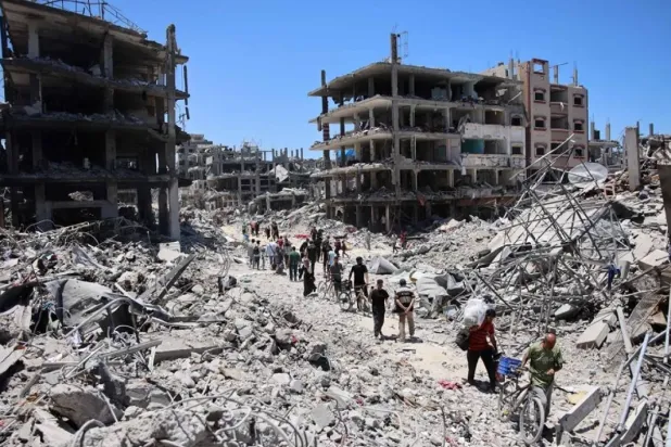 Palestinians carry some salvaged belongings as they leave the Jabalia refugee camp in the northern Gaza Strip after they returned briefly to check on their homes on May 31, 2024, amid the ongoing conflict between Israel and Hamas. (AFP)