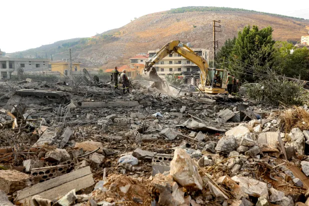 An excavator digs as rescuers search for survivors amidst the rubble following an overnight Israeli airstrike on the village of Kfar Rumman in southern Lebanon on September 7, 2026. (AFP) 