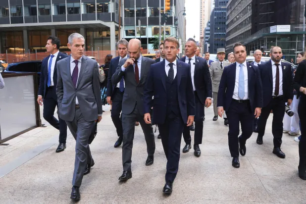 French President Emmanuel Macron (R) walks with Jerome Bonnafont (L), Permanent Representative of France to the United Nations and France’s Foreign Affairs Minister Jean-Noel Barrot (C) as they arrive at Trump Tower in New York City on September 21, 2026, ahead of a meeting with US President Donald Trump. (AFP) 