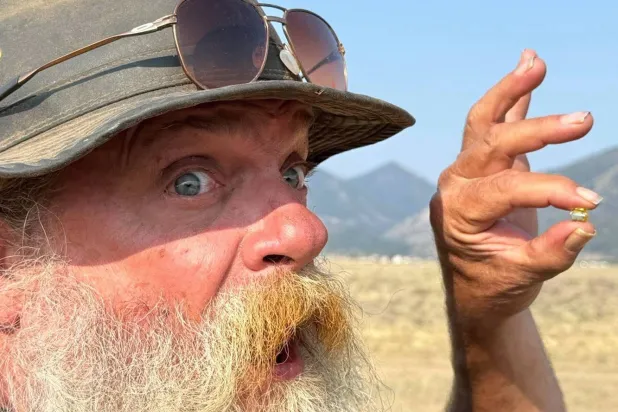 This photo provided by Jack Pearadin shows Brian Busse on Aug. 9, 2026, in Buena Vista, Colo., holding a 6-carat diamond found by Pearadin and Michael Schumacher. (Jack Pearadin via AP)
