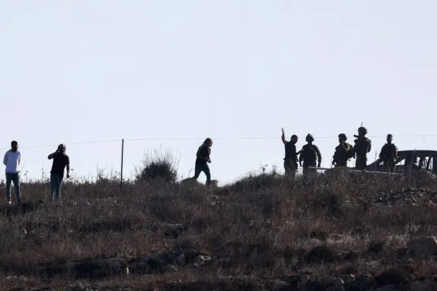 İşgal altındaki Batı Şeria'nın Nablus kentinde İsrailli yerleşimciler ve askerler (AFP)