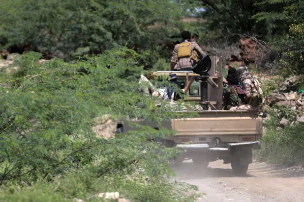 Yemen government soldiers ride in a pick-up truck near the Jabal Han front, west of the city of Taiz on October 3, 2026. (AFP)