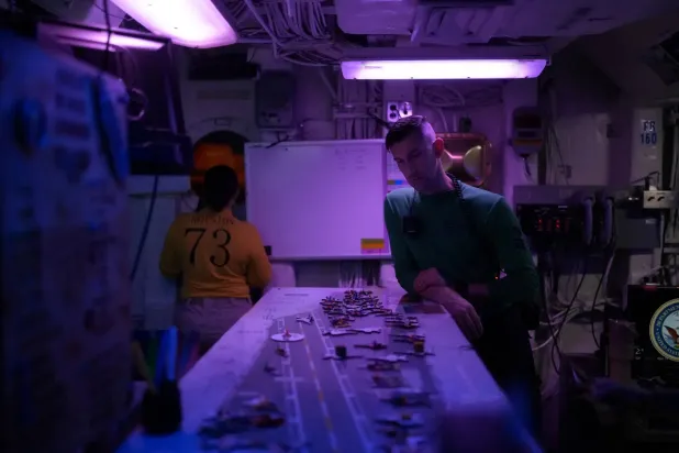 Night Aircraft Handling Officer Breana Royston and AE1 Andrew Schmucker coordinate aircraft positioning aboard the USS George Washington in the Arabian Sea, September 13, 2026 (Reuters)