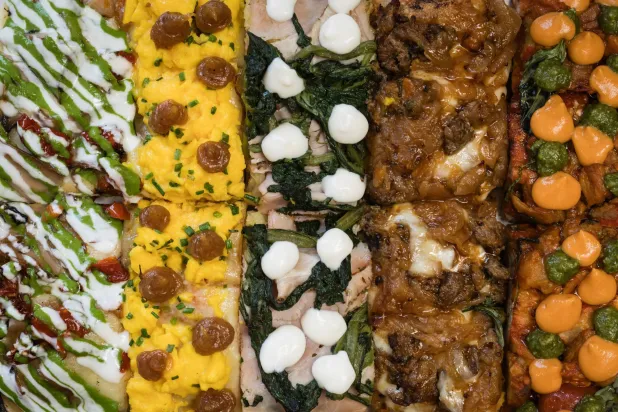 An array of slices of pizza al taglio at Frumentario (The New York Times)