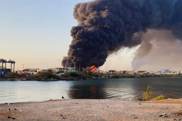 A view shows a large plume of smoke and fire rising from fuel depot in Port Sudan on May 6, 2025. (AFP)