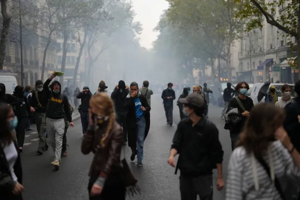 Students run through tear gas near Sciences Po university as they protest against under-resourced schools, in Paris, Wednesday, Oct. 7, 2026. (AP) 