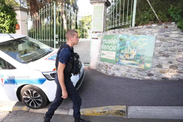 (FILES) A police officer passes in front of the entrance of the Musee Renoir after four paintings were stolen in an early-morning break-in, with two recovered in the museum's garden and two still missing, in Cagnes-sur-Mer on September 8, 2026. (Photo by Valery HACHE / AFP)