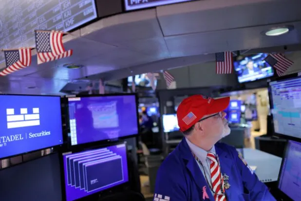 A trader works on the trading floor at the New York Stock Exchange (NYSE) in Manhattan, New York City, US, November 11, 2022. REUTERS/Andrew Kelly/File Photo