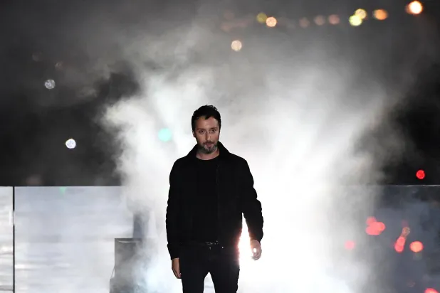 (FILES) Belgian designer for Saint Laurent Anthony Vaccarello acknowledges the audience at the end of the women's 2018 Spring/Summer ready-to-wear collection fashion show in Paris, on September 26, 2017. (Photo by ALAIN JOCARD / AFP)