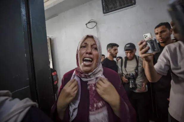 A Palestinian woman weeps during the funeral of an eight-year-old boy killed in an Israeli airstrike in Gaza City on Friday. (EPA)