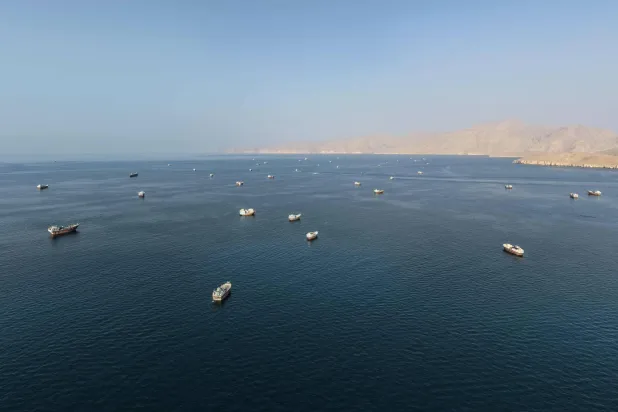 An aerial view shows ships anchored off the coast of Khasab in Oman's Musandam Governorate, near the Strait of Hormuz, on October 2, 2026. (Photo by AFP)