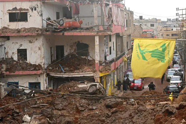 This photograph taken during a media tour organized by Hezbollah shows a flag of Hezbollah installed on the balcony of a damaged building at Nabi Sheet town after an Israeli military operation in the Bekaa Valley of Lebanon, on March 7, 2026. (Photo by FADEL itani / AFP)