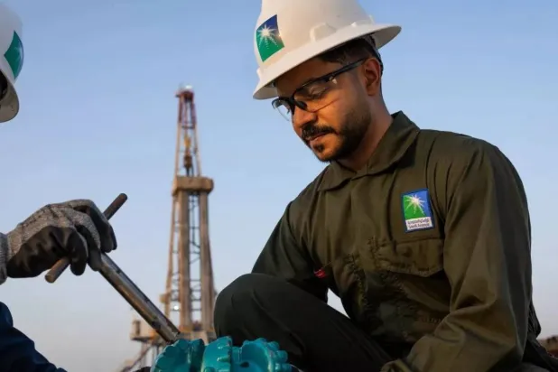 Two workers carry out tasks at one of Saudi Aramco's facilities. (Aramco)