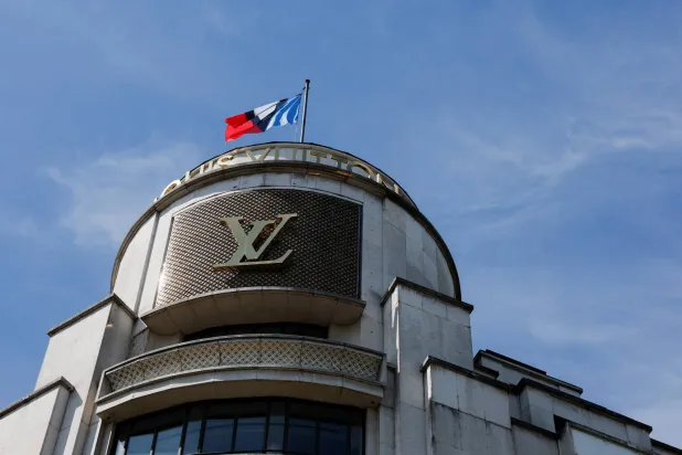 FILE PHOTO: A Louis Vuitton logo is seen outside a store on the Champs-Elysees avenue in Paris, France, August 3, 2025. REUTERS/Stephanie Lecocq/File Photo