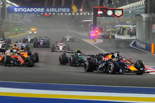 Red Bull driver Max Verstappen of the Netherlands leads the field after the start of the Singapore Formula One Grand Prix race in Singapore, Sunday, Oct. 11, 2026. (AP Photo/Vincent Thian)