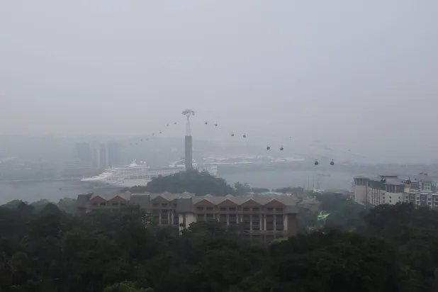 Singapore cable cars travelling towards Mount Faber station are shrouded in haze as smoke from regional forest fires reduces visibility across the city-state, in Singapore, October 14, 2026. REUTERS/Suhaimi Abdullah