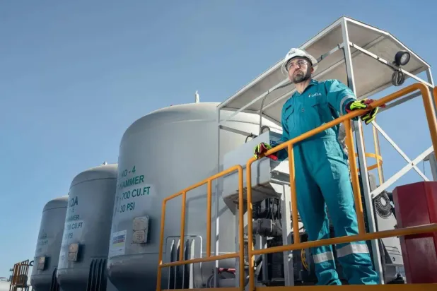 A technician monitors TAQA’s field operations. (Company handout)